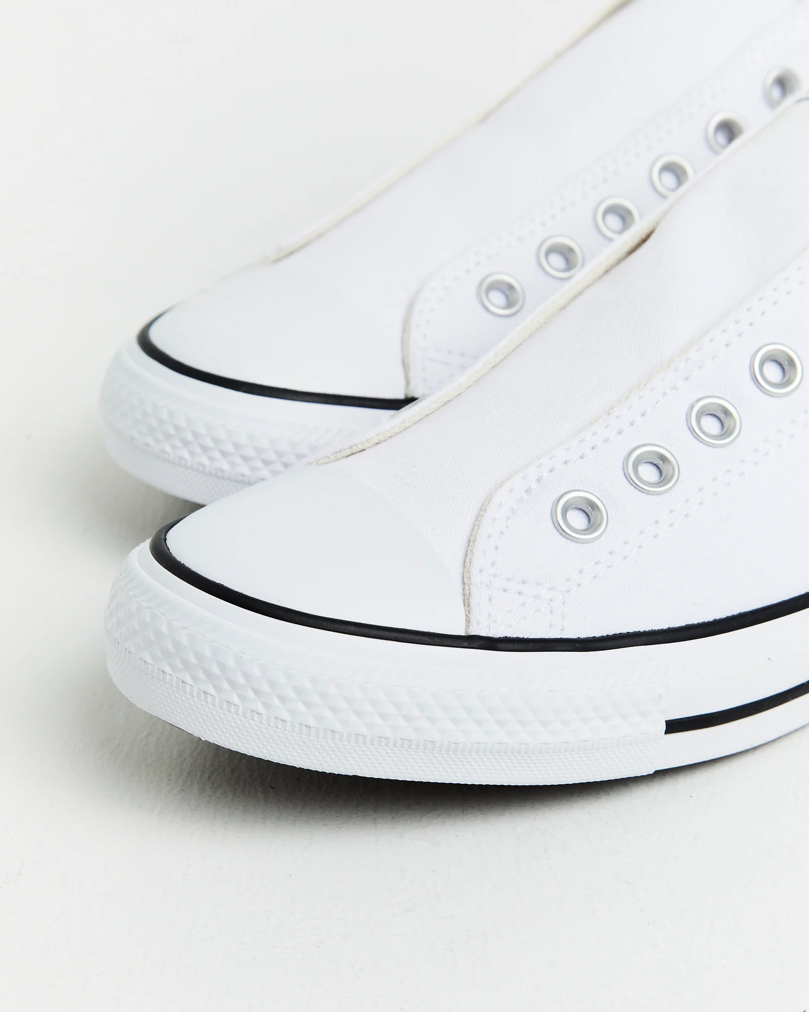 Chuck Taylor All Star Slip On Sneakers In White/Black - Image 5